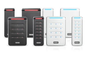 A modern office setting with a sleek, digital security terminal prominently featured in the foreground. On the terminal screen, vibrant icons representing various access credentials like passwords, biometric scans, and smart cards are illuminated. In the middle ground, a diverse group of professionals dressed in business attire are engaged in discussions, examining access control options with focused expressions. The background features blurred office elements, such as glass walls and abstract security graphics, creating a high-tech ambiance. Soft, warm lighting enhances the professional atmosphere, while a slight depth of field adds focus on the terminal. The composition conveys a sense of security, collaboration, and technological advancement in access control systems. hid signo readers product range family shot